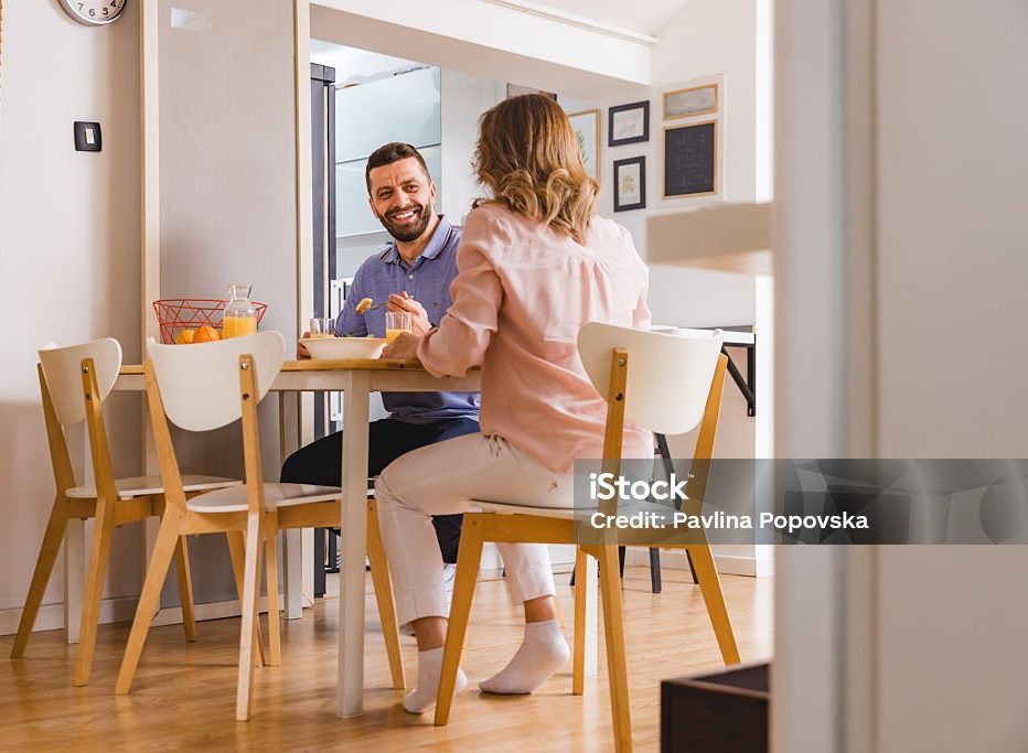 Husband and wife in the dining room, having breakfast